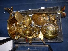 A box of brass items to include an oil lamp reservoir, candlestick holders, trays, jugs,