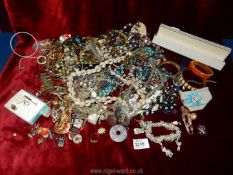 A large quantity of costume jewellery, vintage beads, bangles, etc.