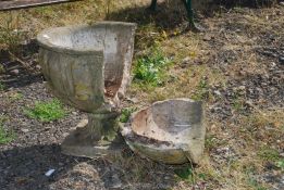 A large pedestal planter in need of restoration.