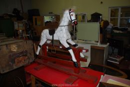 A wooden rocking horse 46" long.