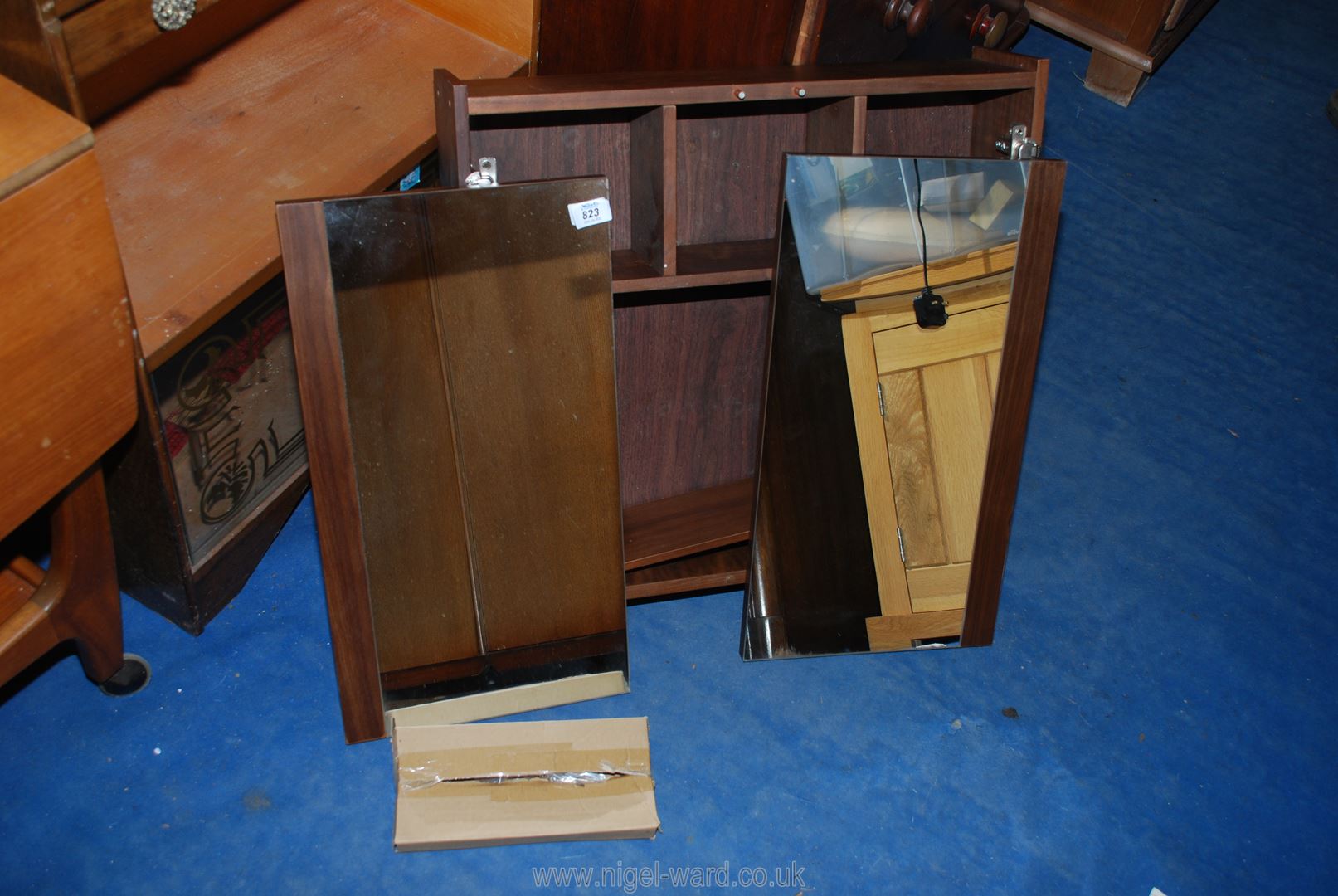 A flat pack mirror fronted cabinet 2' wide x 21" high.