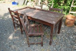A wooden patio set including 4 chairs and a table 59" long x 28" wide x 27" high (in need of