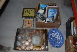 Two boxes of glass, china and miscellanea including two wall clocks, willow meat plate, etc.