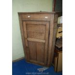 A large corner cupboard 55" high x 33" wide x 18" deep.