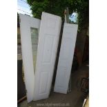 White wardrobe doors on runners plus one other with central glass panel.