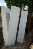 White wardrobe doors on runners plus one other with central glass panel.