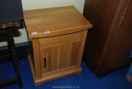 A small pine effect cupboard 20" wide x 15" deep x 2' high.