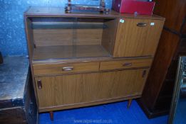 A mid century sideboard with glass sliding door 14" deep x 4' wide x 46 1/2" high.
