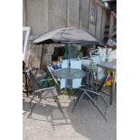A glass topped garden patio set with 4 chairs and parasol, table 31'' diameter x 28'' high.
