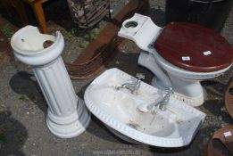 A close coupled toilet pan and large basin with pedestal and back stand.