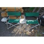 Two fold-up picnic chairs with side table attached.