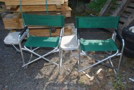 Two fold-up picnic chairs with side table attached.