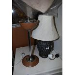 A table lamp and cream shade and an ashtray.