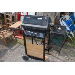 A gas 'Char-Broil' 5000 DLX barbecue with single ring burner to one side.