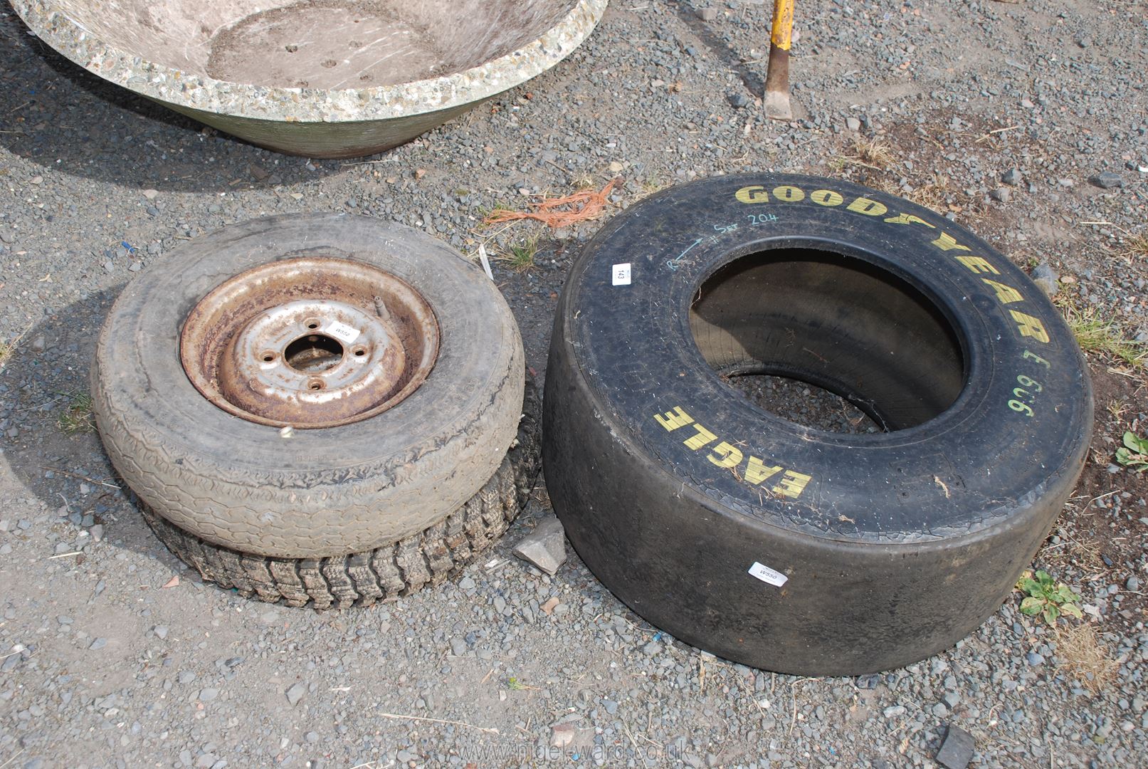 A Good Year racing car tyre 25.5 x 9.5. x 13 and two mini tyres; including one Mud & Snow tyre.