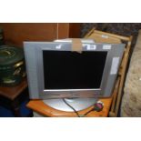 A large 15" screen TV with remote.