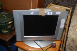 A large 15" screen TV with remote.