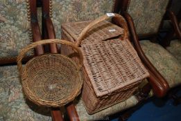 A wicker picnic basket and another basket.