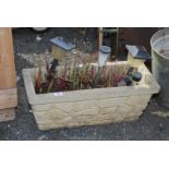 A concrete planter 26" x 11" x 10 1/2" h.