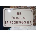 An enamel sign 'Rue Francois de la Rochefoucauld'.