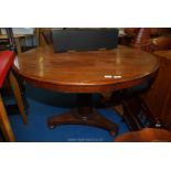 A circular dining table on pedestal base 46" diameter.