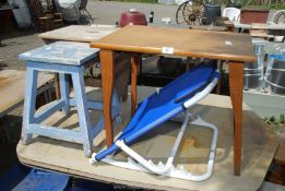 A wooden folding occasional table, adjustable bed backrest and two stools.