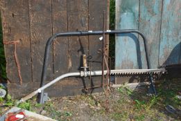 A metal stand and aluminium part hedge cutter head and tubular frame.
