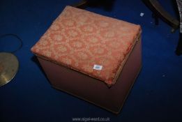 A small upholstered Ottoman and a lamp shade.