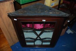 A glazed corner cupboard.