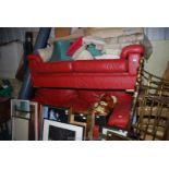 A two seater settee in red leather and two matching chairs.