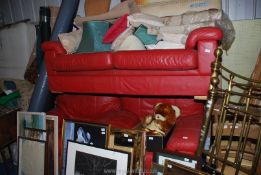 A two seater settee in red leather and two matching chairs.