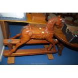 A wooden rocking horse with horse hair tail, 53" long.
