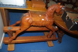 A wooden rocking horse with horse hair tail, 53" long.