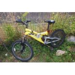 A yellow 6 speed mountain bike with shock absorbers.