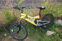 A yellow 6 speed mountain bike with shock absorbers.