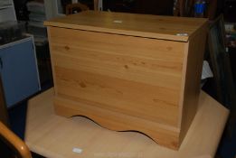 A wooden toy box 27" x 14" x 20" high.