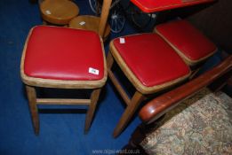 Three faux leather top stools.