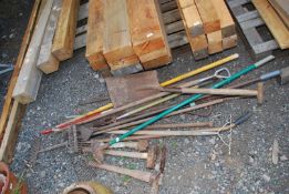 A quantity of garden tools - small axe, rakes, shovel etc.
