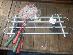 Four badminton rackets and adjustable dog guard