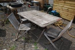 A rectangular teak garden table with four chairs by 'Kent Collection',