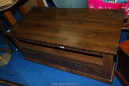 A heavy coffee table with drawers.