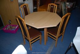 An octagonal table with 4 chairs, 43" x 29 1/2" high.