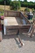 A wooden trailer with spoked wheels.