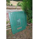 A green painted external stable type door.
