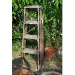 A vintage 4 rung step ladder.