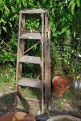 A vintage 4 rung step ladder.