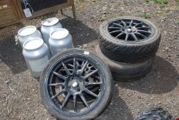 Four black alloy wheels, three with part worn tyres 205/40ZR x 17.