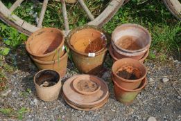 A small quantity of terracotta pots and saucers.