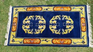 A Cobalt blue ground Tibetan rug with dragon guls, a/f., approx. 35" x 65".