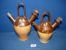 Two Royal Doulton Old Sarum kettles, both having wooden stoppers, crack to spout on small one,